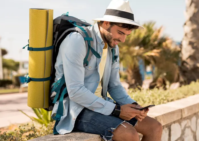 sideways-traveler-looking-phone-copia?format=webp&width=700&quality=75